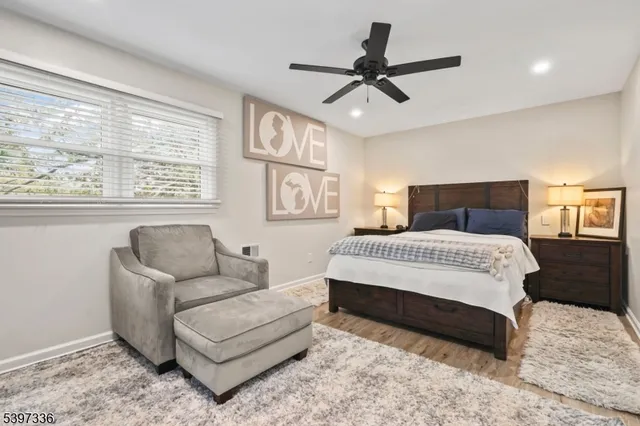 a bedroom with a bed couch and window