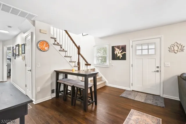 a view of entryway dining room and hall with wooden floor