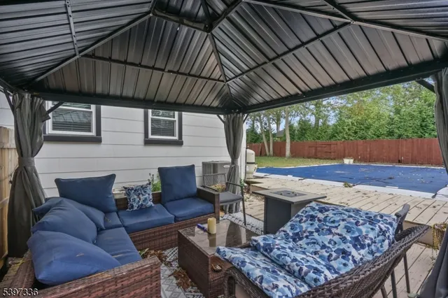 a outdoor living space with patio furniture and a fireplace