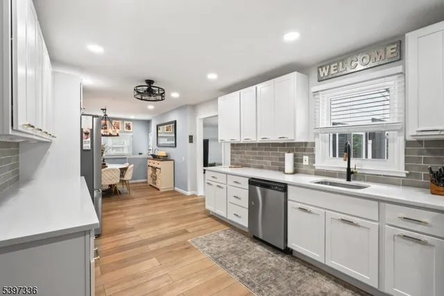a kitchen with a sink window and cabinets