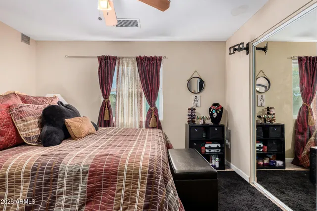 a bathroom with a granite countertop sink mirror vanity and toilet