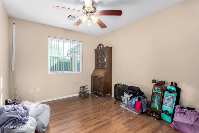 a view of a workspace with furniture and wooden floor