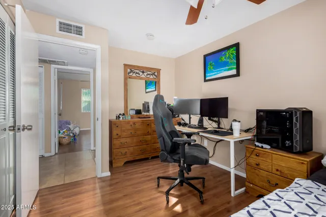 a bedroom with a bed and a desk