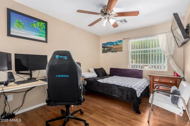 a bedroom with a bed and a flat screen tv