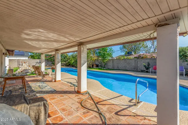 a view of a house with swimming pool and a yard
