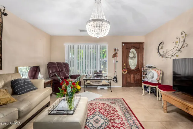 a living room with furniture a rug a clock and a window