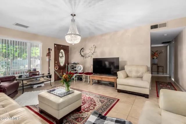 a living room with furniture a flat screen tv and a large window