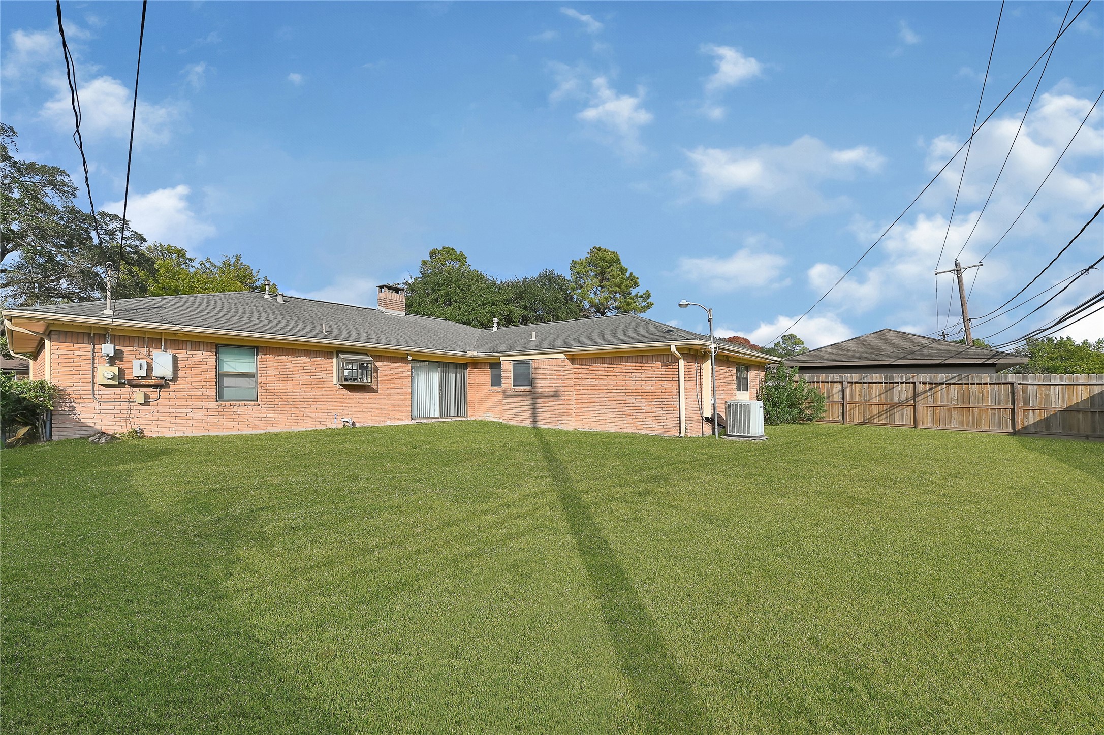 4831 Knickerbocker Street Houston, TX 77035 - Photo 48 of 50 Full view of the fenced backyard, providing security and privacy for residents/pets.