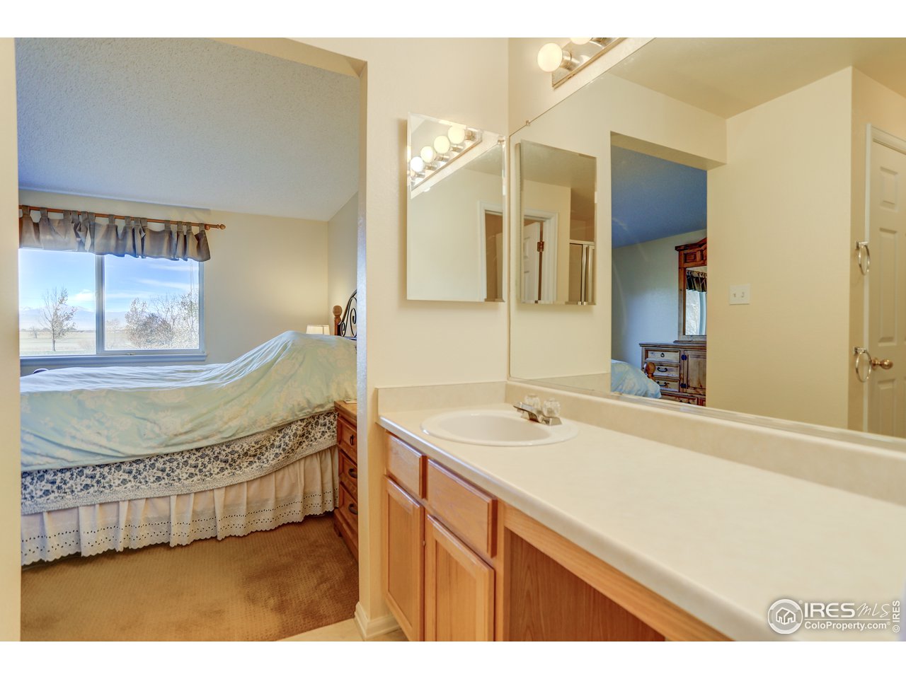 5403 Bobcat Street Frederick, CO 80504 - Photo 22 of 40 a en suite bathroom with a sink mirror and bathtub