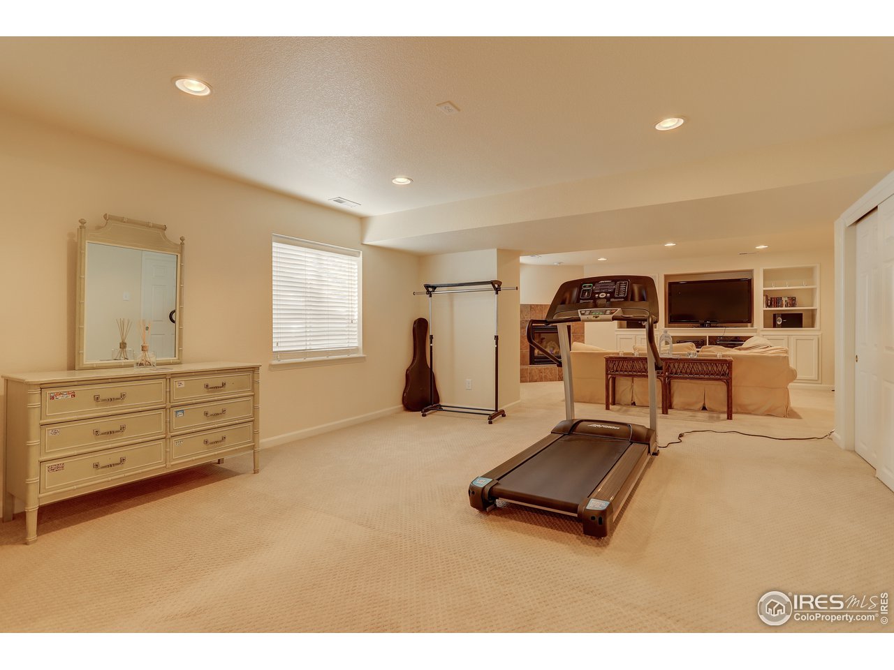 5403 Bobcat Street Frederick, CO 80504 - Photo 25 of 40 a room with gym equipment and view of living room