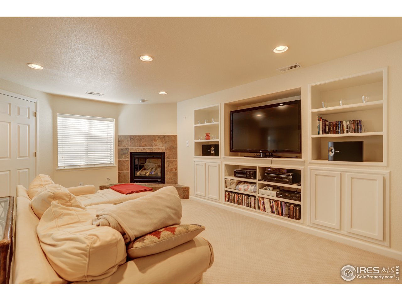 5403 Bobcat Street Frederick, CO 80504 - Photo 26 of 40 a living room with furniture and a flat screen tv