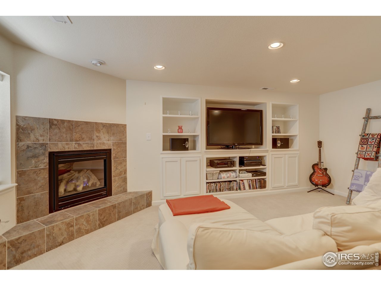 5403 Bobcat Street Frederick, CO 80504 - Photo 27 of 40 a living room with furniture and a flat screen tv