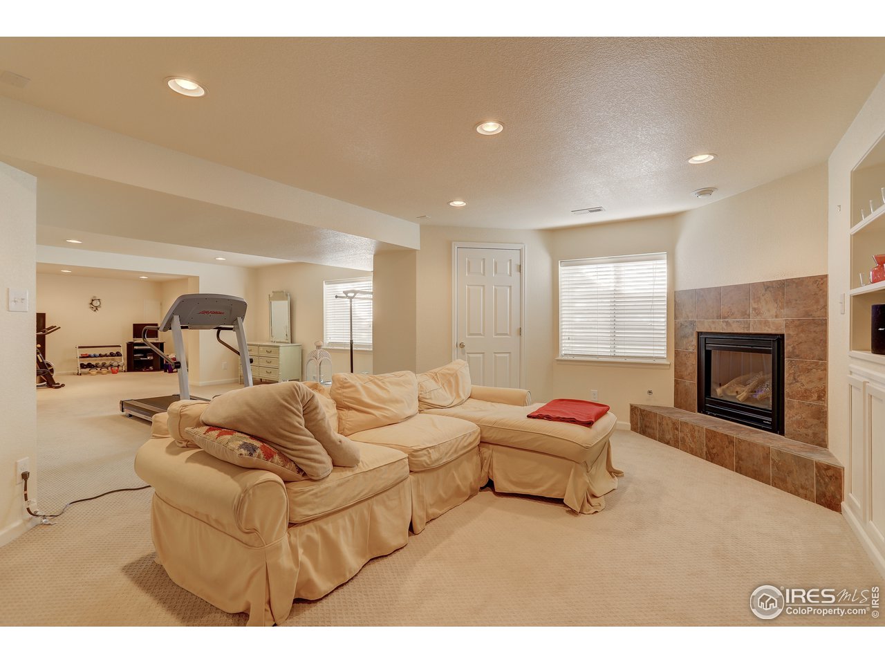 5403 Bobcat Street Frederick, CO 80504 - Photo 28 of 40 a living room with furniture and a fireplace