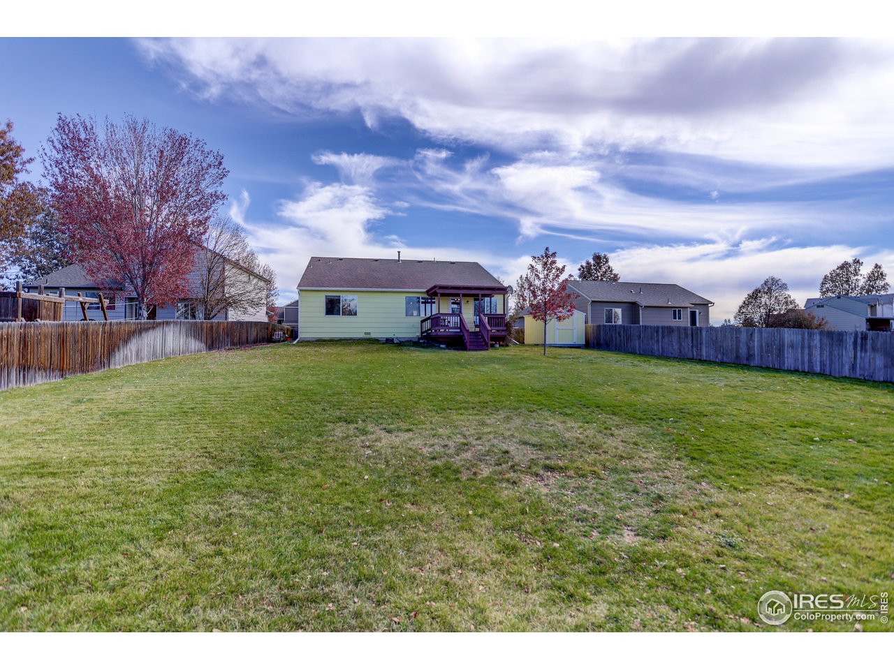 5403 Bobcat Street Frederick, CO 80504 - Photo 34 of 40 a view of a house with a big yard and large trees