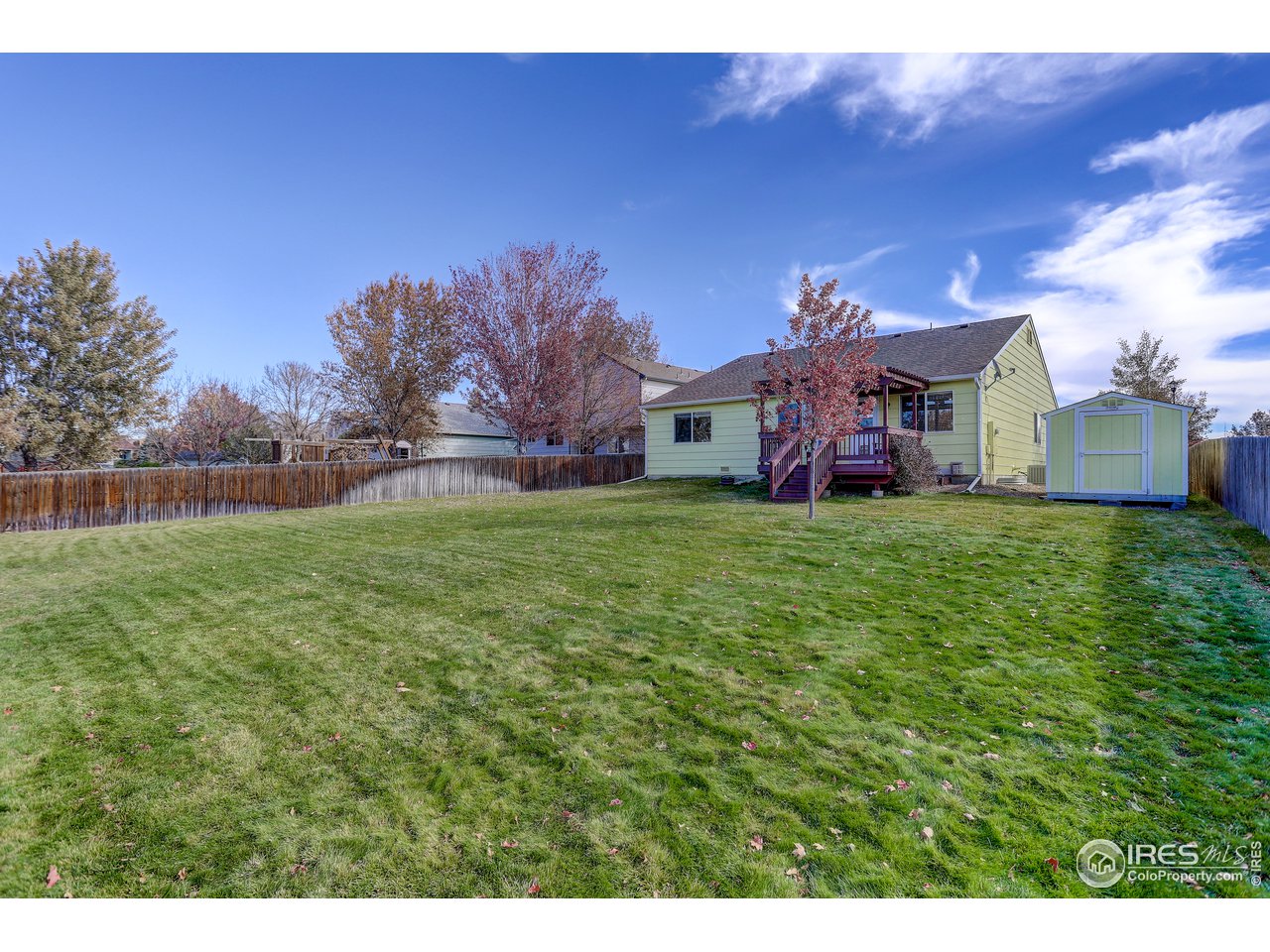 5403 Bobcat Street Frederick, CO 80504 - Photo 38 of 40 a view of a house with a big yard and large trees
