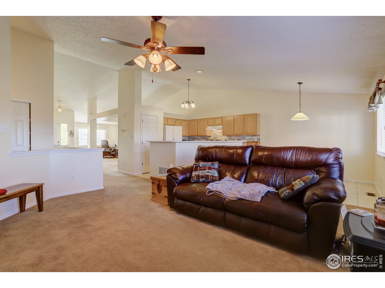 5403 Bobcat Street Frederick, CO 80504 - Photo 10 of 40 a living room with furniture and a chandelier