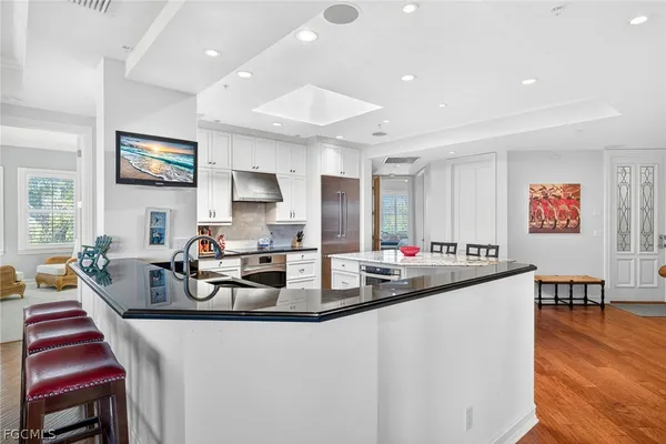 a view of a dining room with furniture wooden floor and a flat screen tv