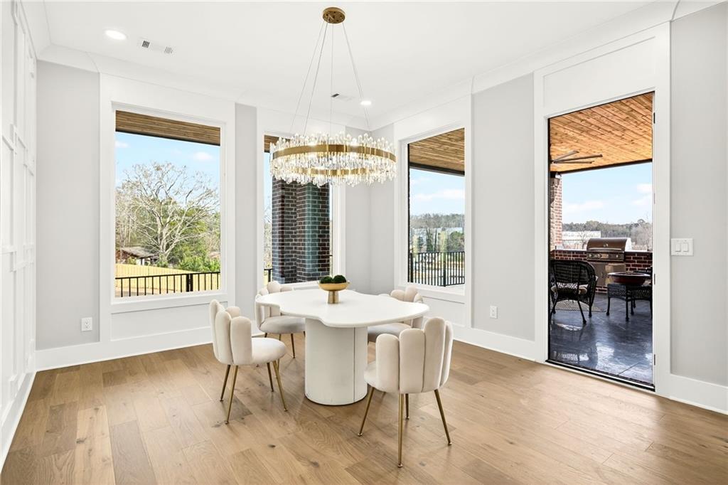 403 Thunder Road Buford, GA 30518 - Photo 39 of 88 a view of a dining room with furniture window and wooden floor