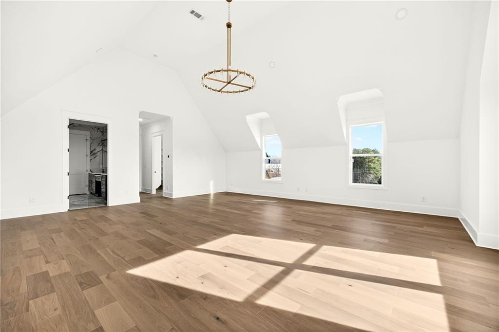 403 Thunder Road Buford, GA 30518 - Photo 75 of 88 a view of a room with wooden floor and a ceiling fan