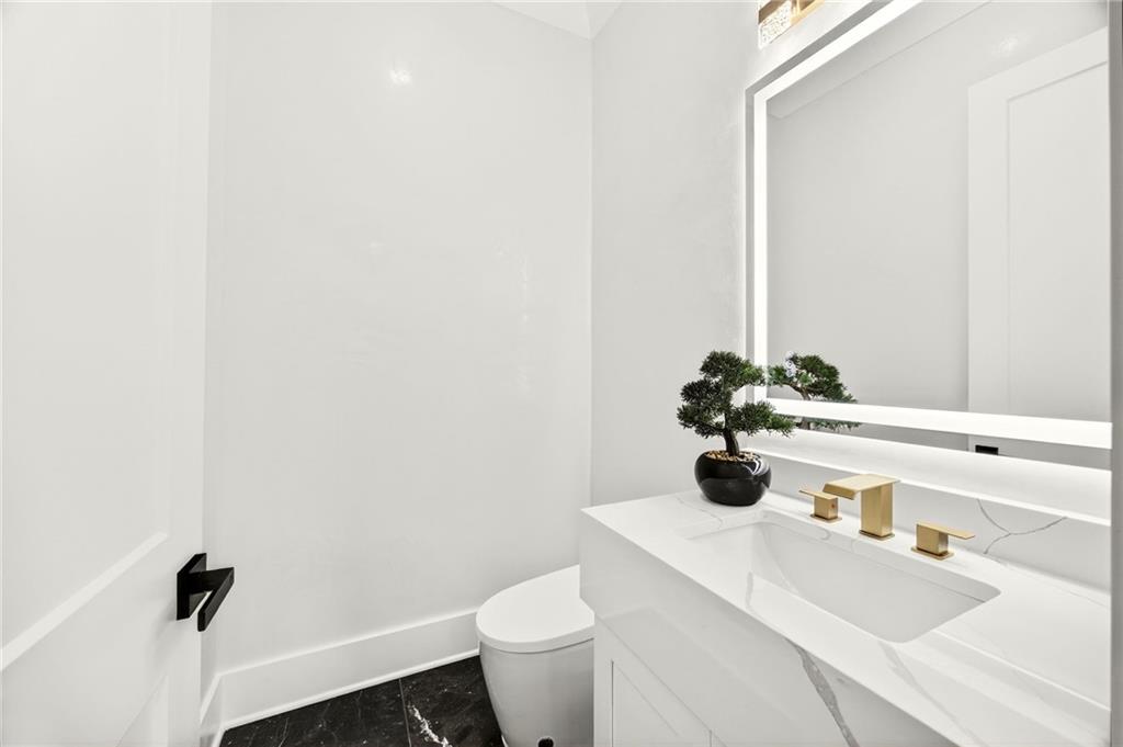 403 Thunder Road Buford, GA 30518 - Photo 78 of 88 a bathroom with a sink and a toilet