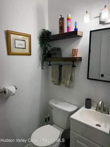 a bathroom with a toilet a sink and a mirror