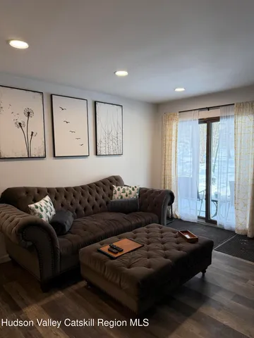 a living room with furniture and large window