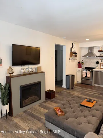 a living room with furniture and a fireplace or television