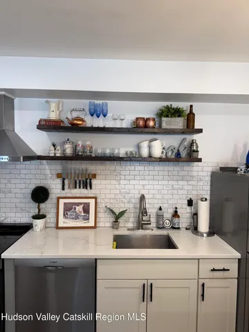 a view of a bedroom with wooden floor and a window