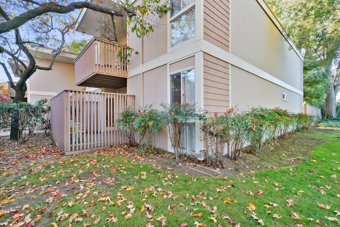 a view of a house with a small yard and plants