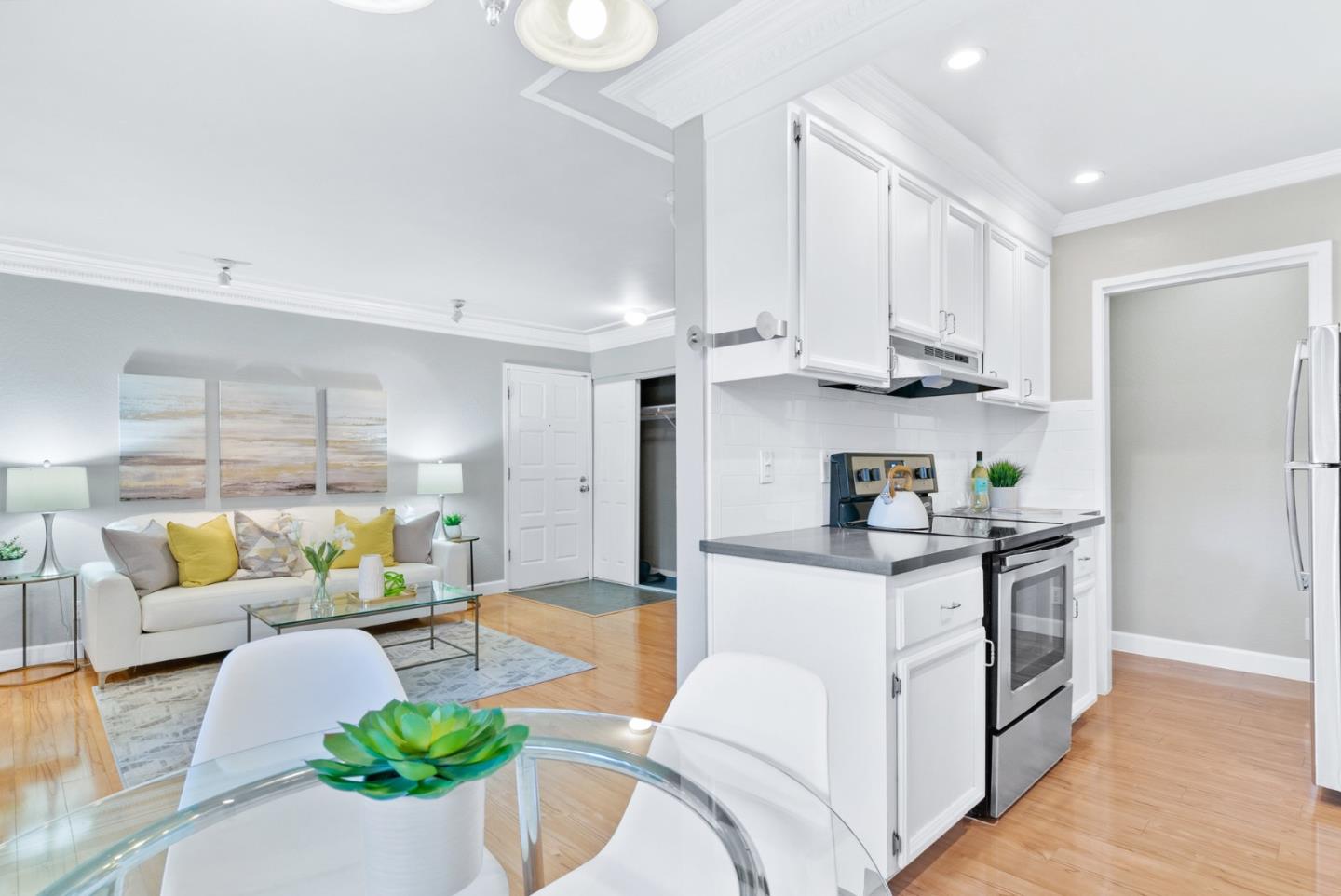 280 Easy Street, Unit 403 Mountain View, CA 94043 - Photo 11 of 21 a kitchen with stainless steel appliances kitchen island granite countertop a table and chairs in it