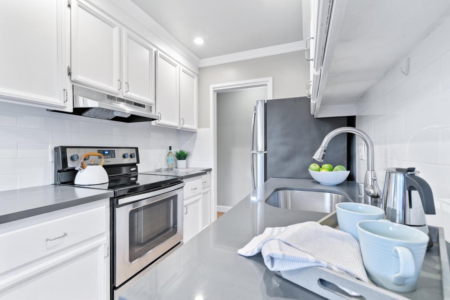 280 Easy Street, Unit 403 Mountain View, CA 94043 - Photo 12 of 21 a kitchen with stainless steel appliances granite countertop a sink a stove and a refrigerator