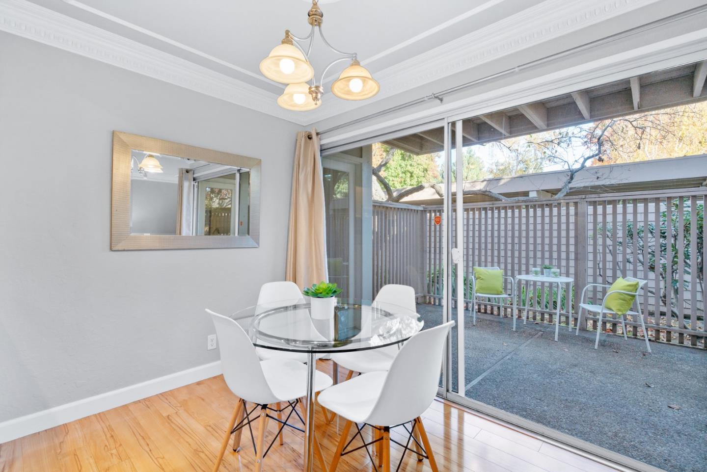 280 Easy Street, Unit 403 Mountain View, CA 94043 - Photo 9 of 21 a view of a dining room with furniture a chandelier and wooden floor