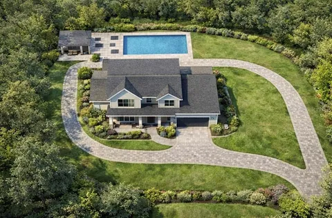 an aerial view of a house with outdoor space