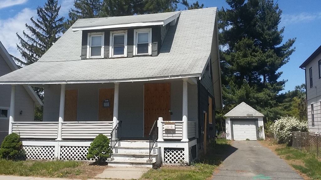 82 Miller Street Springfield, MA 01104 - Photo 1 of 8 a front view of a house with a garden