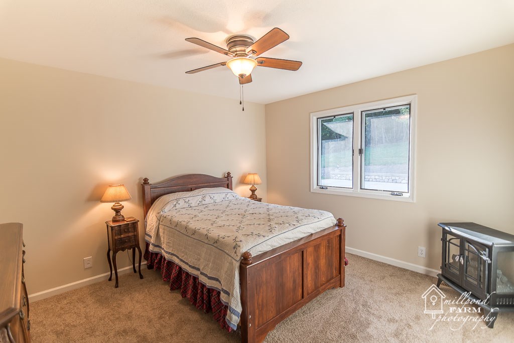 201 East View Lane Raphine, VA 24472 - Photo 38 of 50 a bedroom with a bed and a chandelier