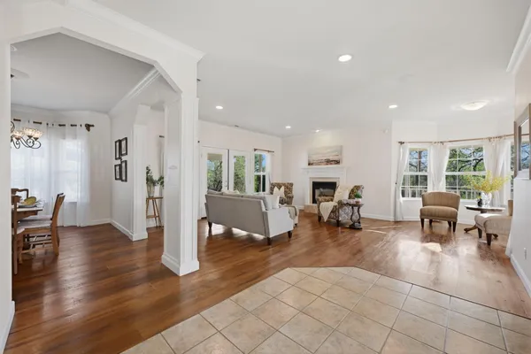 a living room with furniture a flat screen tv and a large window