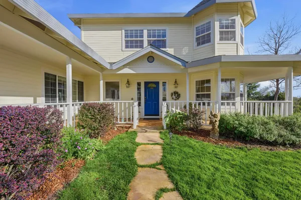 a front view of a house with garden