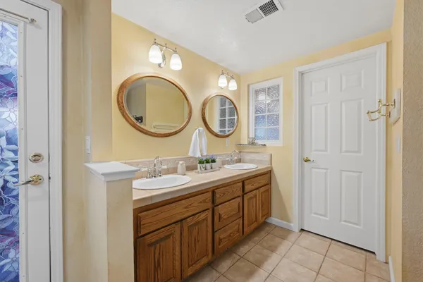 a view of a backyard with couches under an umbrella
