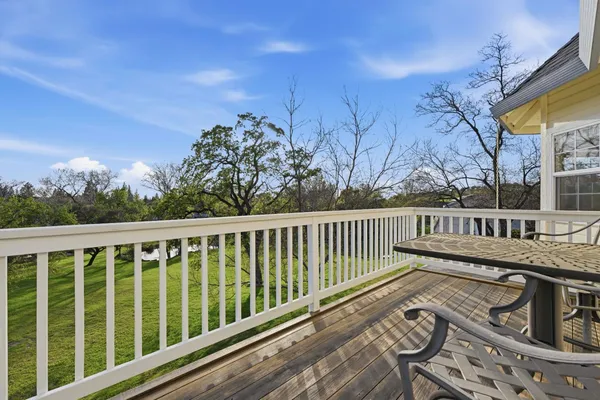 a view of a lake with lawn chairs and a table