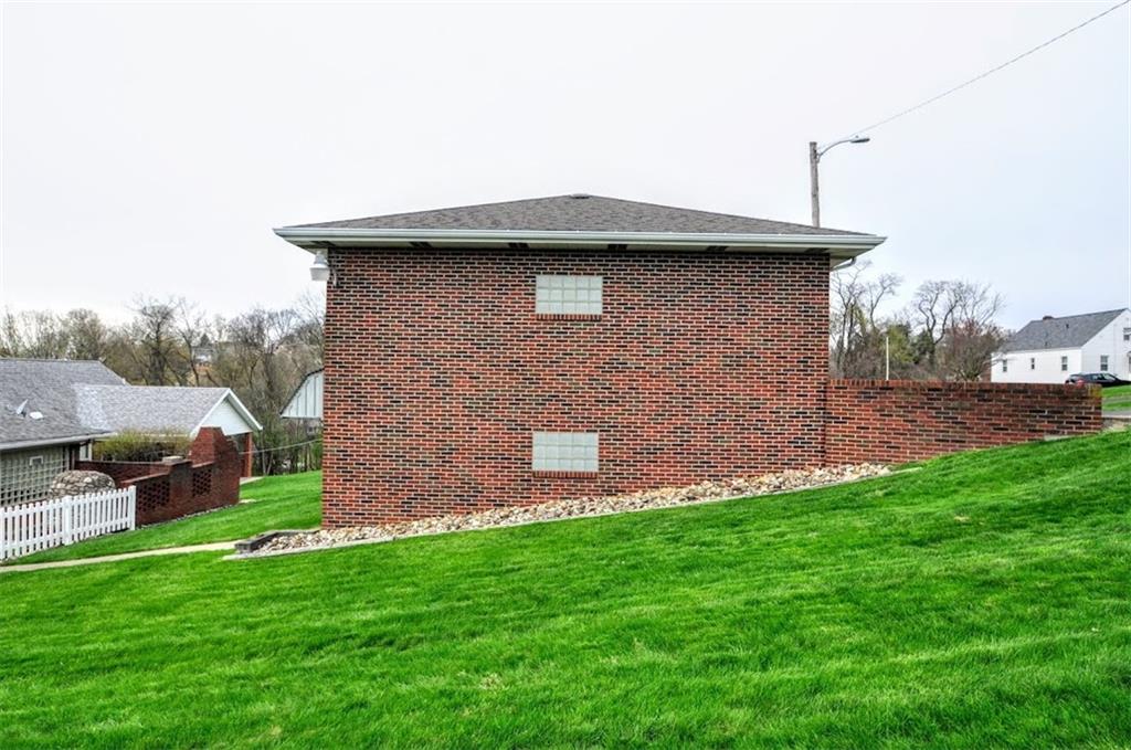 65 Cort Street Washington, PA 15301 - Photo 19 of 49 a brick house with a small yard