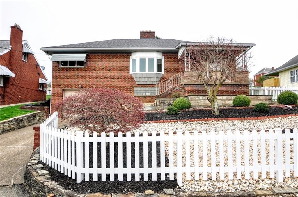 65 Cort Street Washington, PA 15301 - Photo 2 of 49 a front view of a house with garden