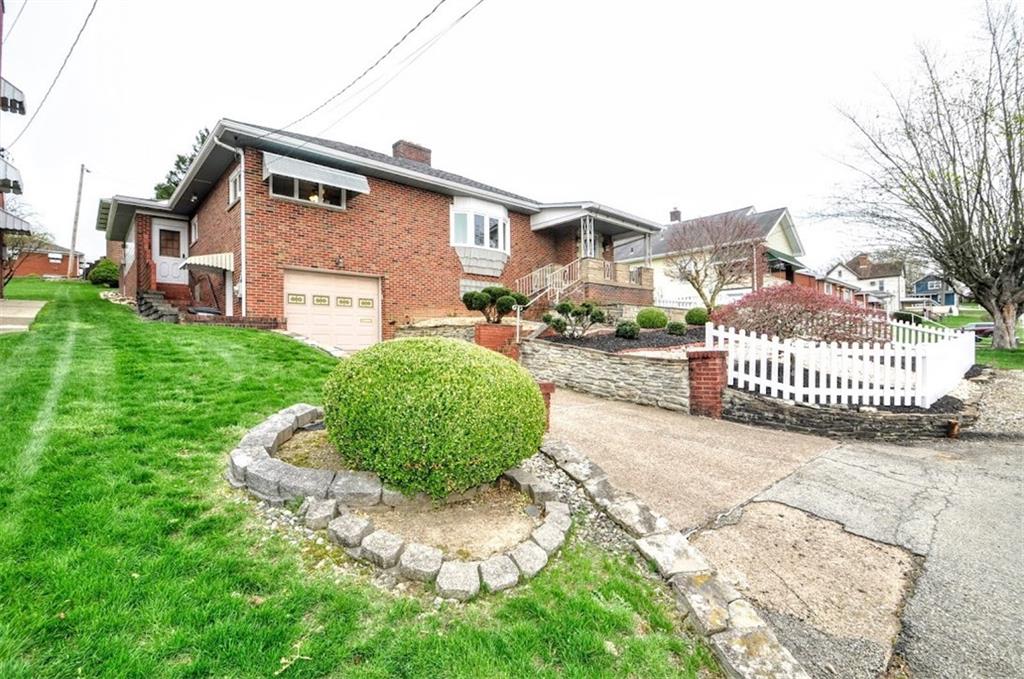 65 Cort Street Washington, PA 15301 - Photo 4 of 49 a front view of a house with a yard and garage