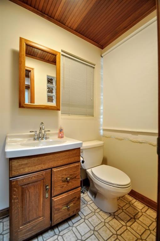 65 Cort Street Washington, PA 15301 - Photo 43 of 49 a bathroom with a granite countertop toilet a sink and a mirror