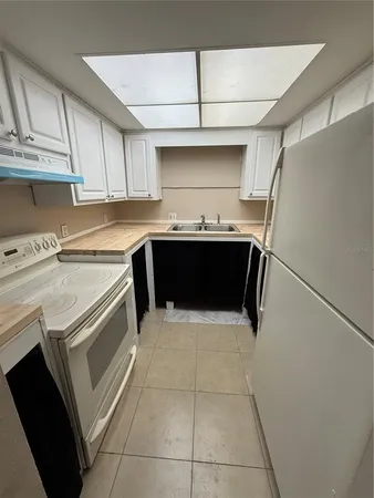 a kitchen with a cabinets and refrigerator