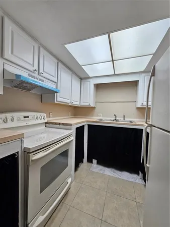a kitchen with a stove and a refrigerator