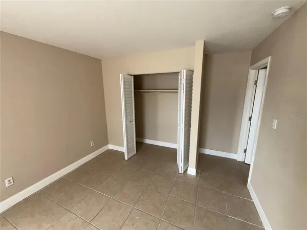 a view of an empty room and closet area
