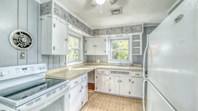 a kitchen with a sink stove and cabinets