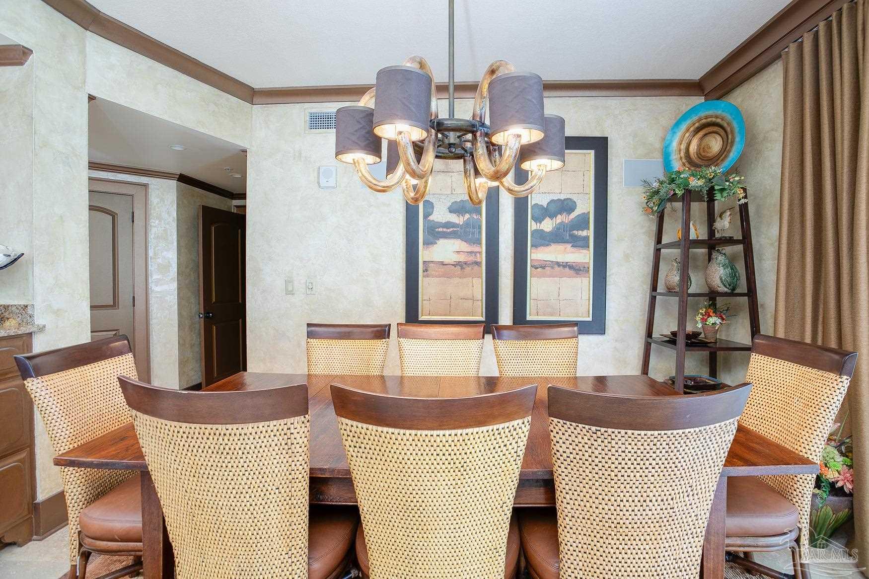 16795 Perdido Key Drive, Unit 40304B Perdido Key, FL 32507 - Photo 28 of 42 a dining room with chandelier and wooden floor