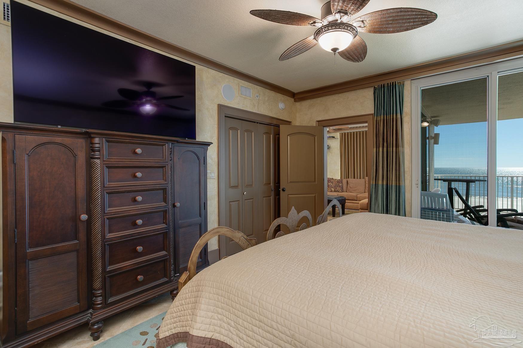 16795 Perdido Key Drive, Unit 40304B Perdido Key, FL 32507 - Photo 30 of 42 a bedroom with a bed and a flat screen tv