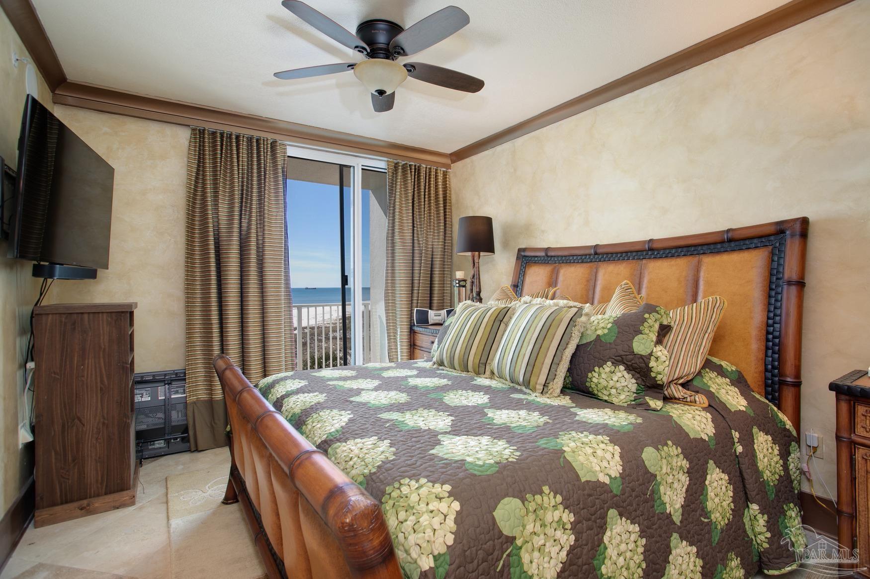 16795 Perdido Key Drive, Unit 40304B Perdido Key, FL 32507 - Photo 33 of 42 a bedroom with a large bed and a flat tv screen on dresser